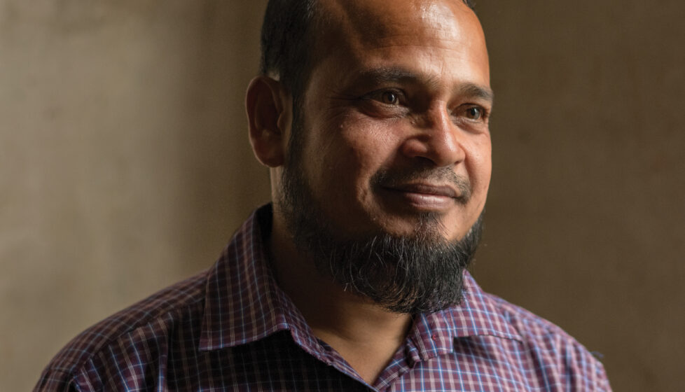 Man smiles at person off camera